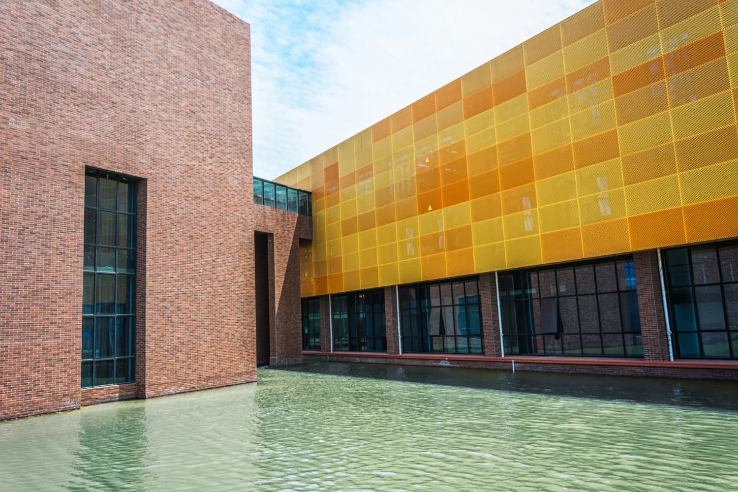 Modern commercial building facade with aluminum composite panel cladding and integrated concrete waterproofing by Watech in Lagos.