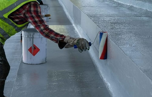 Application of structural waterproofing membrane on a building foundation in Nigeria
